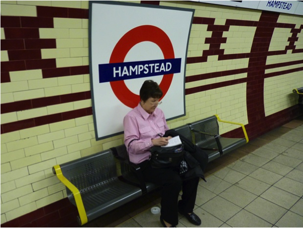 Naomi writing in Hampstead Tube station